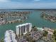 Elevated exterior view of a condo complex surrounded by water and residential neighborhoods at 9495 Blind Pass Rd # 907, St Pete Beach, FL 33706