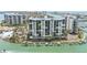 Aerial of condominium complex on waterfront featuring boat docks at 9495 Blind Pass Rd # 907, St Pete Beach, FL 33706