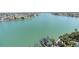 Aerial view of a waterfront property with a boat dock and stunning turquoise waters at 9495 Blind Pass Rd # 907, St Pete Beach, FL 33706