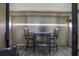 A small outdoor table and chair set is featured on a balcony space at 9495 Blind Pass Rd # 907, St Pete Beach, FL 33706