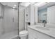 Clean and bright bathroom with tiled walk-in shower, vanity, and framed mirror at 9495 Blind Pass Rd # 907, St Pete Beach, FL 33706