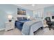 This bedroom features blue walls and bedding, a ceiling fan, and beach themed artwork at 9495 Blind Pass Rd # 907, St Pete Beach, FL 33706