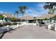 Inviting clubhouse entrance framed by palm trees and well-maintained landscaping at 9495 Blind Pass Rd # 907, St Pete Beach, FL 33706