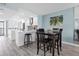 Open dining area with wood table and chairs adjoins the kitchen with stainless steel appliances at 9495 Blind Pass Rd # 907, St Pete Beach, FL 33706