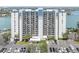 Modern high-rise condominium building featuring ample parking and picturesque waterfront views at 9495 Blind Pass Rd # 907, St Pete Beach, FL 33706