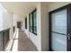 Outdoor hallway with doors leading to condo units overlooking water at 9495 Blind Pass Rd # 907, St Pete Beach, FL 33706