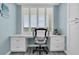 Bright home office features a custom built-in desk, storage, white cabinets, and shuttered windows at 9495 Blind Pass Rd # 907, St Pete Beach, FL 33706