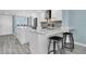 Bright kitchen with marble counters, island, and ample counter space with stools at 9495 Blind Pass Rd # 907, St Pete Beach, FL 33706