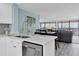 View of modern kitchen with marble counters and stainless steel appliances at 9495 Blind Pass Rd # 907, St Pete Beach, FL 33706