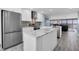 Open kitchen floor plan with stainless appliances and adjoining living area at 9495 Blind Pass Rd # 907, St Pete Beach, FL 33706