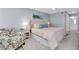 Calm main bedroom with an upholstered headboard, soothing colors, and ensuite bathroom at 9495 Blind Pass Rd # 907, St Pete Beach, FL 33706