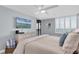 Comfortable main bedroom with light walls, ceiling fan, and balcony access at 9495 Blind Pass Rd # 907, St Pete Beach, FL 33706