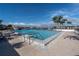 Beautiful waterfront pool area with comfortable lounge chairs and scenic views at 9495 Blind Pass Rd # 907, St Pete Beach, FL 33706