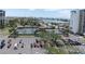 Aerial view of multiple tennis courts and a parking lot close to the beach at 9495 Blind Pass Rd # 907, St Pete Beach, FL 33706