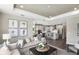 Comfortable living room leading to a modern kitchen featuring stainless steel appliances and an island with bar seating at 9738 Redwood Heights Loop, Thonotosassa, FL 33592
