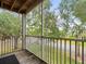Inviting balcony with railing offers a tranquil view of the neighborhood, mature trees and greenery at 10028 Strafford Oak Ct # 712, Tampa, FL 33624