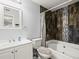 Well-lit bathroom features a shower-tub combo with decorative tile surround, and a vanity with white cabinets at 10028 Strafford Oak Ct # 712, Tampa, FL 33624