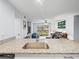 Bright kitchen featuring granite countertops and an open layout connected to the living room and balcony at 10028 Strafford Oak Ct # 712, Tampa, FL 33624