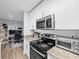 This kitchen has stainless steel appliances, white cabinets and granite countertops at 10028 Strafford Oak Ct # 712, Tampa, FL 33624