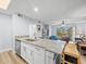 Open-concept kitchen with granite counters overlooking a well-lit living space with vinyl flooring at 10028 Strafford Oak Ct # 712, Tampa, FL 33624