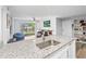 Bright kitchen with granite countertops overlooking the living area and access to the balcony at 10028 Strafford Oak Ct # 712, Tampa, FL 33624