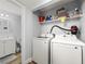 Convenient laundry area with washer, dryer, and shelving for storage located just off the bathroom at 10028 Strafford Oak Ct # 712, Tampa, FL 33624