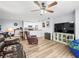 Open-concept living room with ceiling fan and vinyl flooring, seamlessly connected to the kitchen at 10028 Strafford Oak Ct # 712, Tampa, FL 33624