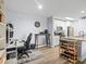 Open living area features a dart board and opens into a kitchen with granite counters and white cabinetry at 10028 Strafford Oak Ct # 712, Tampa, FL 33624