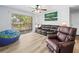 Cozy living room with sliding door access to a balcony overlooking the complex grounds at 10028 Strafford Oak Ct # 712, Tampa, FL 33624