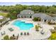 Community pool features a unique shape, lounge chairs, and a clubhouse, all surrounded by landscaping at 10028 Strafford Oak Ct # 712, Tampa, FL 33624