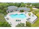 Aerial view of a community pool featuring a unique shape, ample seating, and meticulously maintained landscaping at 10028 Strafford Oak Ct # 712, Tampa, FL 33624