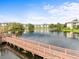 Expansive water view from a wooden walkway in a serene community setting, with lush trees and manicured lawns at 10028 Strafford Oak Ct # 712, Tampa, FL 33624