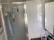 Bright bathroom featuring a glass shower enclosure, tile walls, and vanity at 101 Madonna Blvd, St Petersburg, FL 33715
