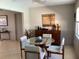 Bright dining area with modern round table, four chairs, and stylish accent cabinet at 101 Madonna Blvd, St Petersburg, FL 33715
