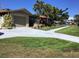 Charming single story home with lush landscaping, well-manicured lawn, and a concrete driveway at 101 Madonna Blvd, St Petersburg, FL 33715