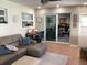 Cozy living room with a brown leather sofa, tile flooring, and sliding doors to the dining area at 101 Madonna Blvd, St Petersburg, FL 33715