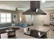 Open-concept living space with modern range hood, comfortable blue sofa, and stylish ceiling fan at 101 Madonna Blvd, St Petersburg, FL 33715