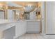 Well-lit bathroom with large vanity, mirrors, and neutral color palette at 1046 Almondwood Dr, Trinity, FL 34655