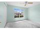 Empty bedroom with a ceiling fan and a large window at 1046 Almondwood Dr, Trinity, FL 34655