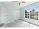 Empty bedroom with closet, ceiling fan and a large window at 1046 Almondwood Dr, Trinity, FL 34655