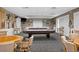 Well-lit billiard room with multiple tables, providing a recreational space for residents and guests at 1046 Almondwood Dr, Trinity, FL 34655