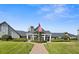 Community clubhouse with manicured lawn and an American flag at 1046 Almondwood Dr, Trinity, FL 34655