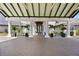 Covered entry to community clubhouse with columns and elegant landscaping at 1046 Almondwood Dr, Trinity, FL 34655