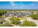 Stunning aerial view of community clubhouse, showcasing its prime location near a golf course and scenic lake at 1046 Almondwood Dr, Trinity, FL 34655