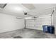 The garage has ample space with a garage door and some trash cans at 1046 Almondwood Dr, Trinity, FL 34655