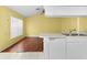 Well-lit kitchen featuring white appliances, tile and hardwood floors, and a large window at 1046 Almondwood Dr, Trinity, FL 34655