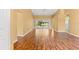 Bright living room featuring a hardwood floor and a view of the outdoor screen porch and backyard at 1046 Almondwood Dr, Trinity, FL 34655