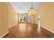 Bright living room featuring a hardwood floor, bright walls, and a large decorative light fixture at 1046 Almondwood Dr, Trinity, FL 34655
