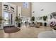Elegant lobby with high ceilings and large windows overlooking the lake at 1046 Almondwood Dr, Trinity, FL 34655