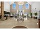 Expansive lobby with high ceilings, elegant chandelier, and abundant natural light, creating a welcoming atmosphere at 1046 Almondwood Dr, Trinity, FL 34655